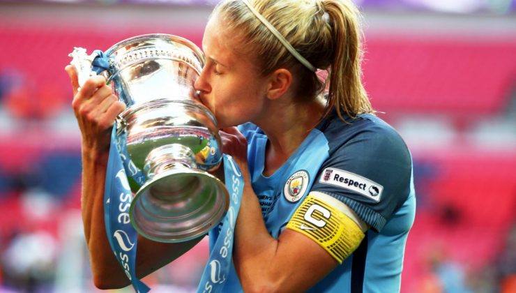 Woman professional footballer kissing cup