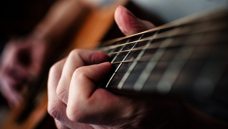hands playing guitar